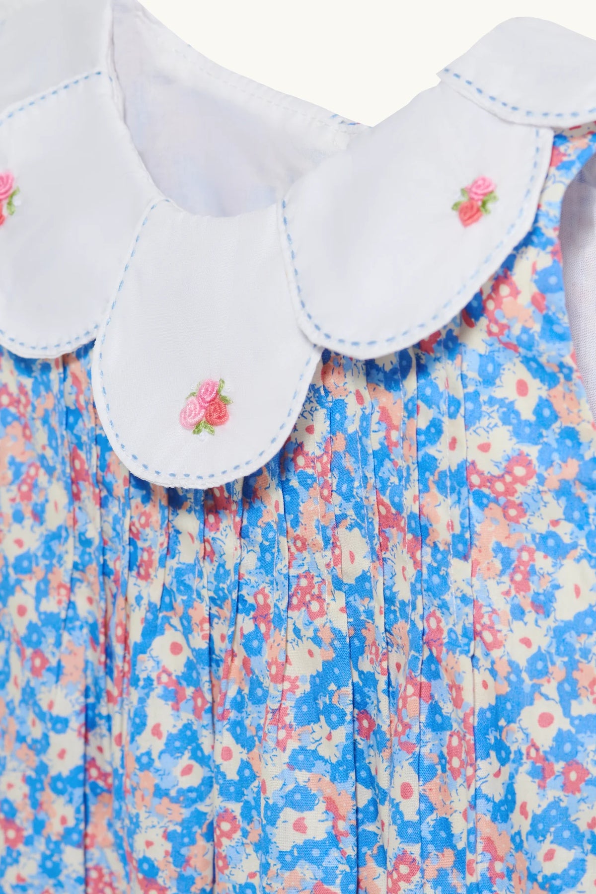 Rosette romper in Sky Blue hand-embroidered cotton lawn